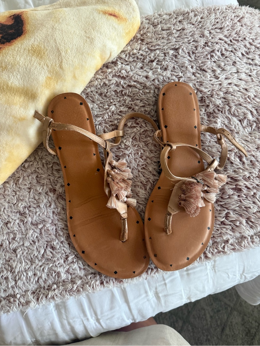 Altar’d Estate 
Women’s Tan Tassel T-Strap Sandals